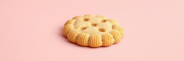 Delicious round cookie with decorative edges sits on a pink background inviting sweet cravings and tasty moments photo