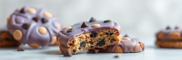 Delicious chocolate chip cookies with purple icing and chocolate chips on a blue background photo