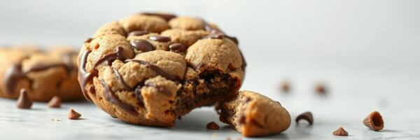 Delicious chocolate chip cookies on a marble countertop with crumbs scattered around photo