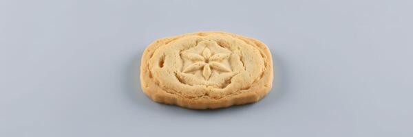 Detailed view of a freshly baked cookie showcasing intricate design and golden color photo