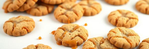 Freshly baked cookies laid out on a white surface with caramel drizzled on some, inviting a sweet treat experience photo