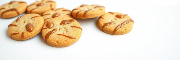 Delicious freshly baked cookies with drizzled caramel placed on a clean surface photo
