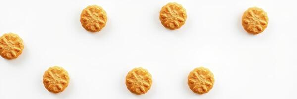 Round golden cookies arranged in a neat pattern on a clean white background suitable for bakery promotion photo