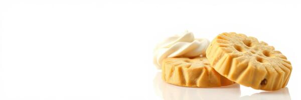Cookies with cream topping arranged on a clean white background for dessert display or baking inspiration photo