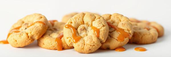 Freshly baked cookies drizzled with caramel placed on a clean white surface photo