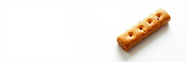 Sweet cookie stick on a white background with chocolate chips and a crispy texture perfect for snacking photo