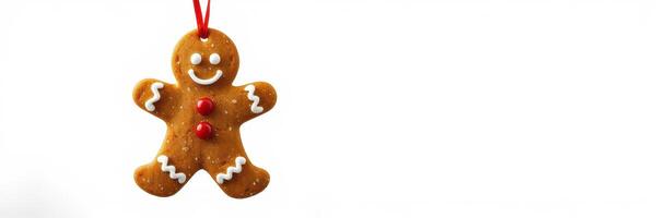 Gingerbread man ornament hanging on a red string ready for holiday decoration photo