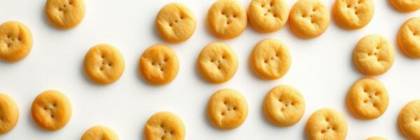 Numerous yellow button-shaped snacks arranged neatly on a white surface inviting sharing and enjoyment photo