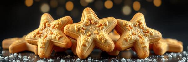 Star-shaped cookies arranged on a dark surface with a blurred festive background during a holiday celebration photo