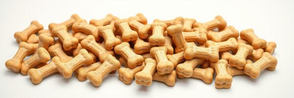 Dog treats arranged in a pile with a classic bone shape, ideal for training and rewarding pets photo