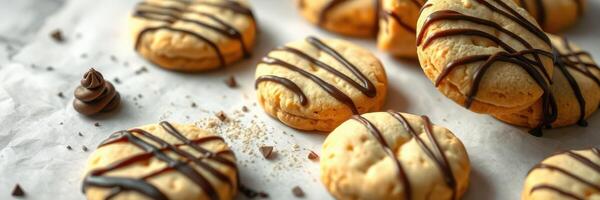 Delicious homemade cookies with chocolate drizzle on parchment paper in a cozy kitchen setting photo