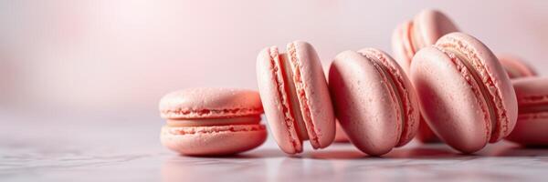 Delicate pink macarons arranged on a marble surface for an elegant dessert display photo