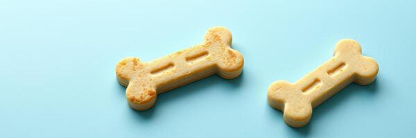 Delicious dog treats in the shape of bones on a light blue background for pets enjoying snack time photo