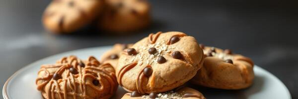 Delicious homemade cookies on a plate with chocolate chips and a sprinkle of sugar set on a dark countertop photo