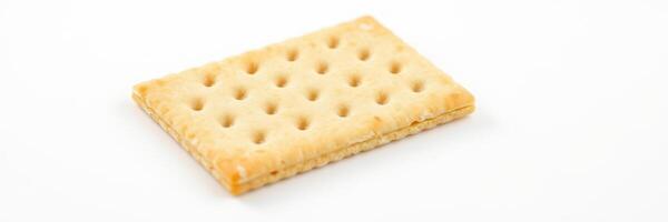 Simple cracker displayed on a white background emphasizing its texture and shape photo