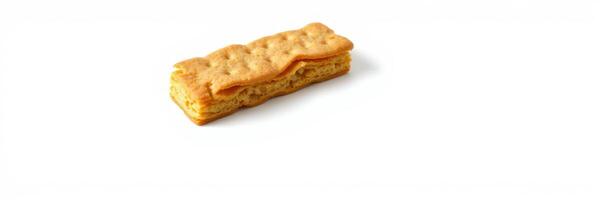 Crunchy golden biscuit with layered texture placed on a clean white surface ready for enjoyment or baking photo