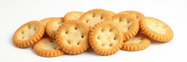 Assorted round crackers piled with a golden brown color on a plain white background photo