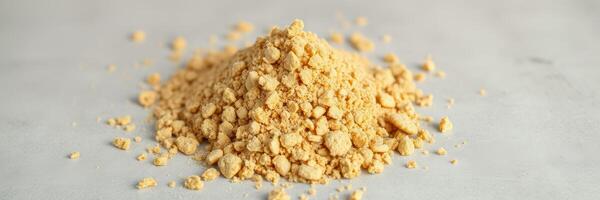 Ground ginger powder pile on a light surface ready for cooking and baking in culinary preparations photo