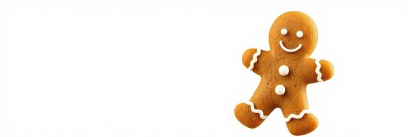 Gingerbread man cookie with a smiling face and decorative icing on a plain background photo