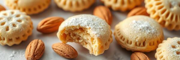 Delicious traditional almond cookies arranged on a marble surface with a bite taken from one cookie photo