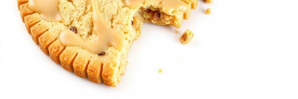 Delicious cookie with creamy frosting and a bite taken out, showcasing its texture and toppings photo