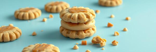Delicious homemade cookies arranged on a bright blue surface with a few cookie crumbs scattered around photo
