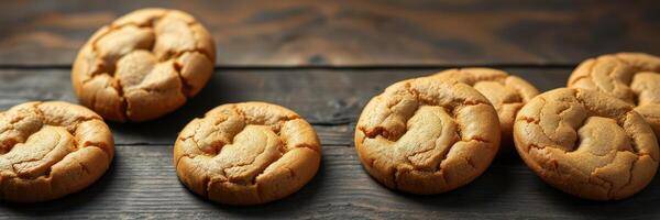 Freshly baked cookies arranged on a wooden table, highlighting texture and warmth in a cozy kitchen setting photo