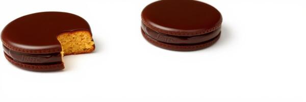Delicious chocolate sandwich cookies arranged on a white surface with one cookie having a bite taken out photo