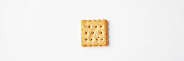 Square cracker on a white background showing texture and detail in a minimalistic setting for food photography photo