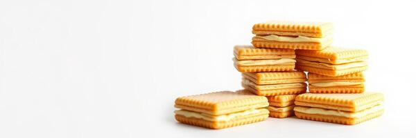 Stacked cream-filled biscuits on a plain background inviting a delightful snack experience photo