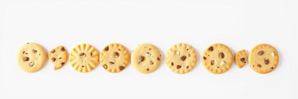 Cookies arranged in a row showcasing different designs and chocolate chip variations photo