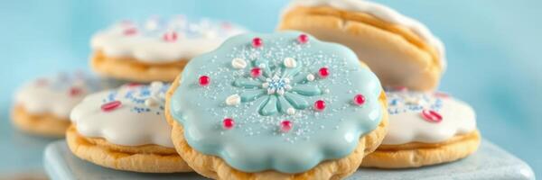 Decorative cookies with intricate icing designs on a blue background displayed on a plate photo