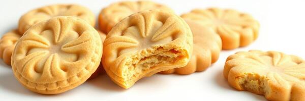 Delicious golden cookies with detailed designs scattered on a white surface photo
