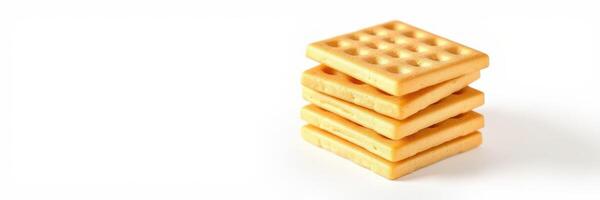 Four stacked golden square wafers arranged neatly on a light background in a simple and inviting manner photo
