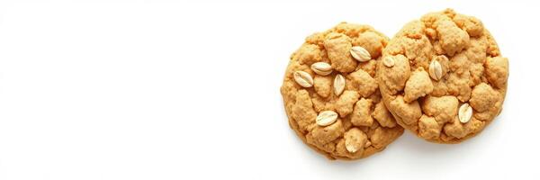 Freshly baked oatmeal cookies topped with oats on a white surface ready to be enjoyed photo