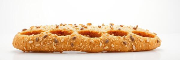 Long, crispy bread stick with sesame seeds on a plain background presenting a snack option in culinary context photo