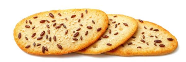 Three crispy flatbreads topped with sesame and flax seeds arranged neatly on a white surface photo