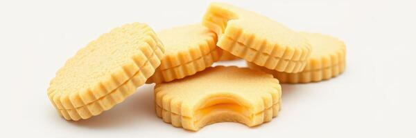 Sweet vanilla cookies arranged with one cookie partially eaten on a plain background photo