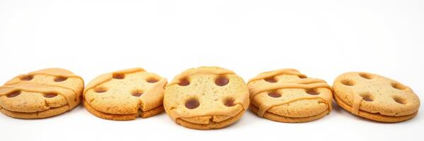 Five golden brown cookies with chocolate chips arranged in a row on a plain white background photo
