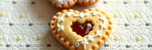 Delicious heart-shaped cookies with berry filling on a patterned cloth photo