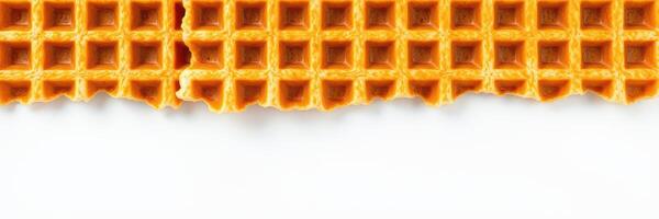 Crispy golden waffle with a bite taken out, highlighting its texture and layering details photo