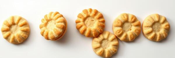Delicious homemade cookies arranged on a white surface with unique floral designs photo