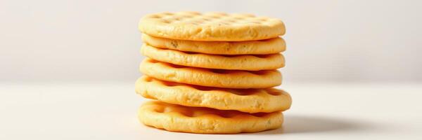 Stacked yellow cookies arranged neatly on a plain background photo
