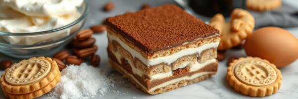 Delicious layered dessert featuring cream, biscuits, and cocoa with coffee beans on a marble countertop photo