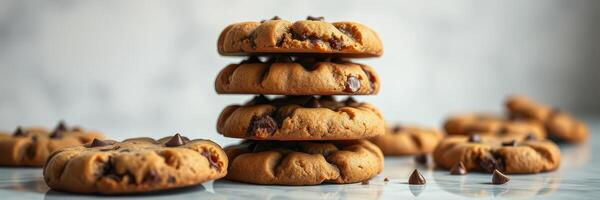 Deliciously baked chocolate chip cookies stacked on a marble surface with scattered chips photo