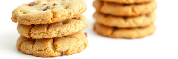 Freshly baked chocolate chip cookies stacked on a white surface with a soft focus background photo