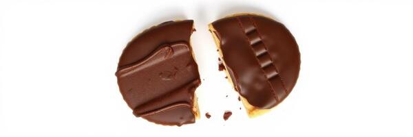 Chocolate cookie split in half showcasing creamy filling and rich chocolate topping on a white background photo