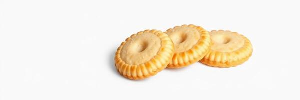 Three round cookies arranged on a plain white surface, showcasing their textured edges and center holes for a delightful treat photo