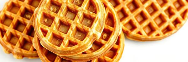 Delicious golden waffles stacked on a white surface ready for breakfast or dessert photo