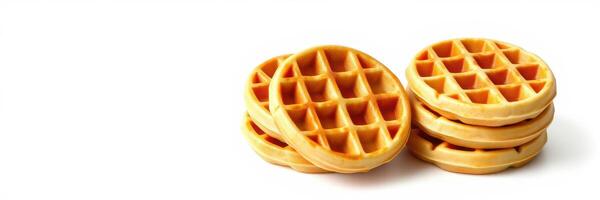 Delicious golden waffles stacked high ready to be served with toppings and syrup for breakfast photo